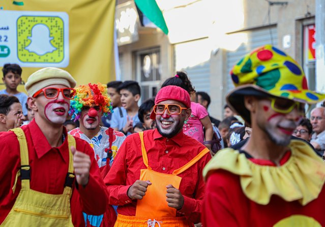 Palestinian young men dressed as clowns perform during an event to entertain children at Jabalia refugee camp in northern Gaza Strip, on September 8, 2022. (Photo by Xinhua News Agency/Rex Features/Shutterstock)