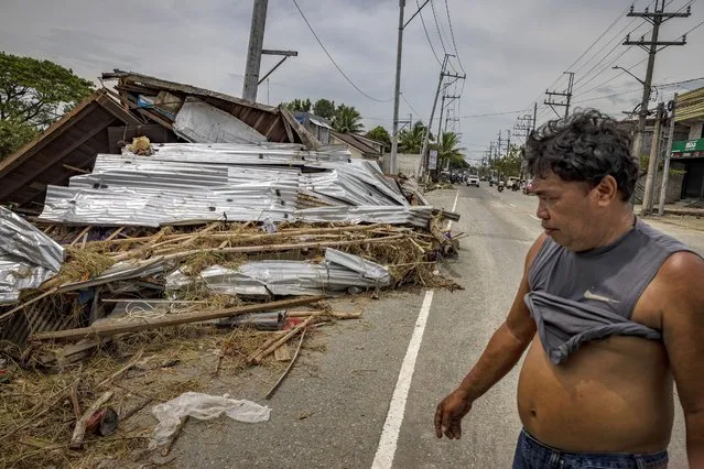 A man walks past a house that was blown away during the onslaught of Super Typhoon Noru on September 26, 2022 in San Miguel, Bulacan province, Philippines. (Photo by Ezra Acayan/Getty Images)