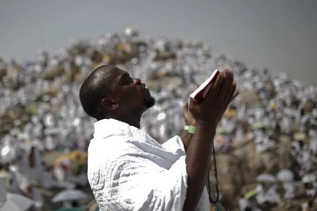 A Muslim pilgrim prays on Mount Mercy on the plains of Arafat during the annual haj pilgrimage, outside the holy city of Mecca September 23, 2015. (Photo by Ahmad Masood/Reuters)