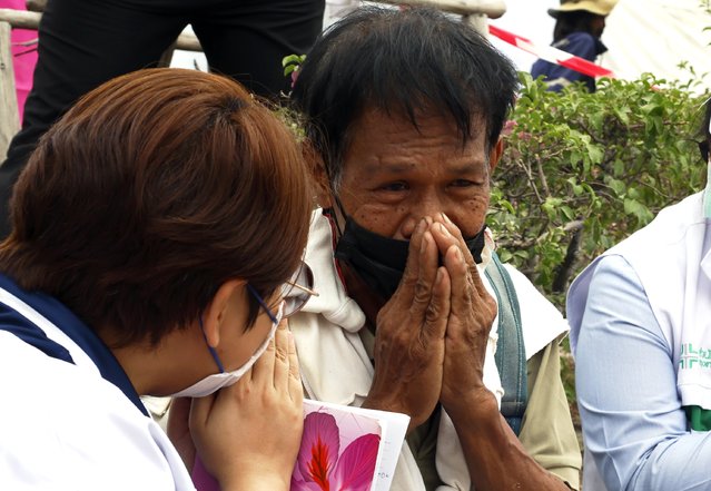 A relative of a missing worker is comforted by a mental health crisis official during a search operation at the site of a building that collapsed following an earthquake in Bangkok, Thailand, 31 March 2025. At least 18 people were confirmed dead, 33 injured, and 78 remained missing in Bangkok, including at least 11 people who were killed after a 30-floor building collapsed due to tremors from the 7.7-magnitude earthquake that struck Myanmar, according to the Royal Thai Police. (Photo by Narong Sangnak/EPA/EFE)