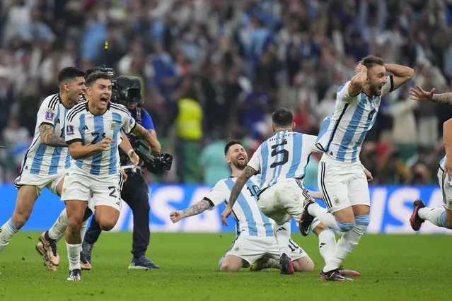 Argentinian players celebrate after winning penalty shootout during the World Cup final soccer match between Argentina and France at the Lusail Stadium in Lusail, Qatar, Sunday, December 18, 2022. (Photo by Petr David Josek/AP Photo)