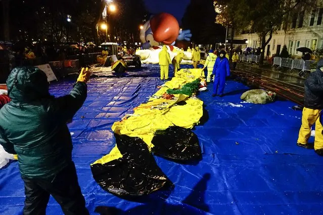 Members of the Macy's Thanksgiving Day Parade balloon inflation team work on a balloon of “Pikachu” during preparations for the 88th annual Macy's Thanksgiving Day Parade in New York, November 26, 2014. (Photo by Eduardo Munoz/Reuters)