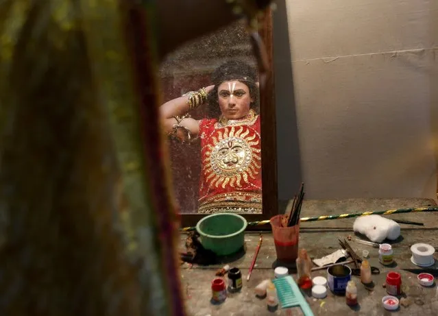 An artist is reflected in a mirror as he gets ready backstage before performing during Ramlila, a re-enactment of the life of Lord Rama, during Dussehra festival celebrations in Mumbai, India, October 22, 2015. Effigies of the 10-headed demon king Ravana are burnt on Dussehra, the Hindu festival that commemorates the triumph of Hindu god Rama over Ravana, marking the victory of good over evil. (Photo by Shailesh Andrade/Reuters)
