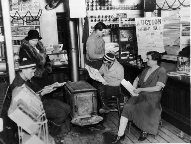 Saddened townspeople at the general store in Plymouth, Vermont read about the passing of their beloved citizen former U.S. President Calvin Coolidge, January 6, 1933. From left to right; Erik Blanchard; Mary Brown, schoolteacher; Robert Goodrich; Herman Pilkey and Miss Florence Cilley, storekeeper and post office clerk. (Photo by AP Photo)