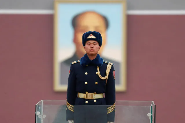 A member of Chinese People's Liberation Army (PLA) stands guard in front of a portrait of late Chinese Chairman Mao Zedong at the Tiananmen in Beijing, China March 4, 2018. (Photo by Damir Sagolj/Reuters)