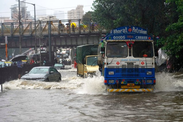 Vehicles ride through a water logged street following heavy rains in Mumbai, India, Tuesday, August 19, 2025. (Photo by Rafiq Maqbool/AP Photo)
