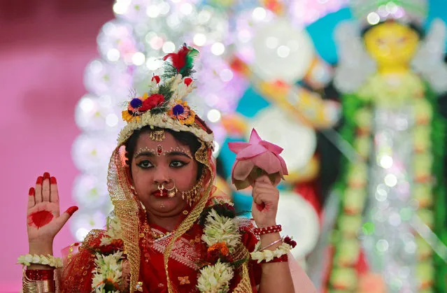 Aishhani Chakraborty, a seven-year old girl dressed as a Kumari, who is worshipped, poses during the Durga Puja festival, in Agartala, India October 9, 2016. (Photo by Jayanta Dey/Reuters)