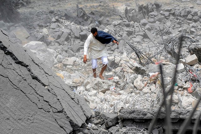 A man walks through the rubble of a collapsed building at the site of a reported US air strike on Yemen's Huthi-held capital Sanaa on March 24, 2025. Yemen's Huthi rebels said one person had been killed and 13 others injured in strikes on Sanaa late on March 23. (Photo by Mohammed Huwais/AFP Photo)
