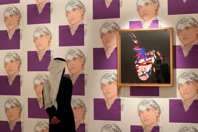 A Saudi man visits an arts exhibition by late US artist Andy Warhol at the Maraya concert hall in the ruins of Al-Ula, a UNESCO World Heritage site in northwestern Saudi Arabia, on February 19, 2023. The first exhibition in Saudi Arabia for the Pop Art giant is a tribute to the late artist's obsession with celebrity, and his seeming ability to predict the rise of contemporary influencer culture. (Photo by Fayez Nureldine/AFP Photo)