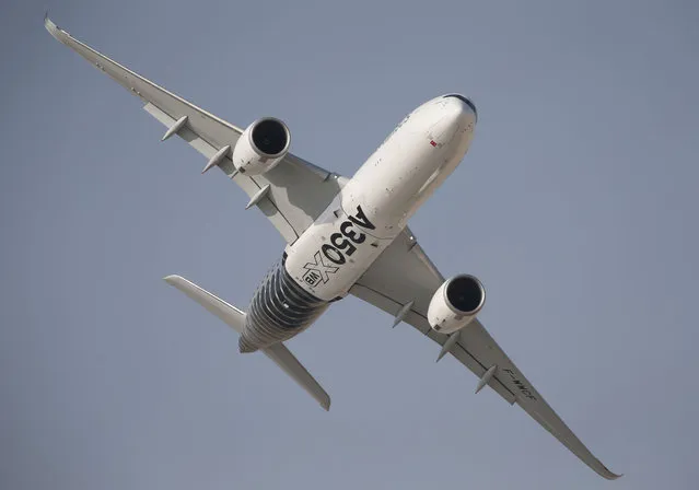 An Airbus A350 XWB performs during the opening of the Dubai Airshow in Dubai, United Arab Emirates, Sunday, November 8, 2015. (Photo by Kamran Jebreili/AP Photo)