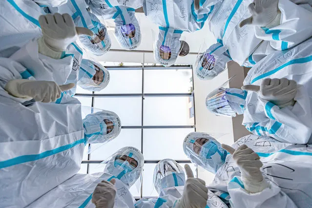 Medical workers work at a nucleic acid testing site in the Binhai New Area on November 22, 2020 in Tianjin, China. (Photo by Wang Yinghao/VCG via Getty Images)