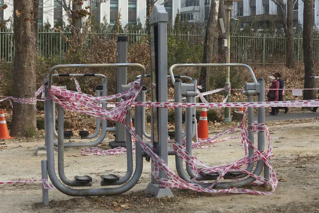 The use of public sports facilities is banned amid social distancing rules at a park in Seoul, South Korea, Friday, December 11, 2020. South Korea is expanding the use of rapid tests and deploying hundreds of police officers and soldiers to help with contact tracing as it deals with its worst surge of coronavirus cases since the early days of the pandemic. (Photo by Ahn Young-joon/AP Photo)