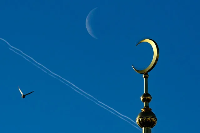 A crescent moon is seen behind Moscow's Sobornaya mosque on December 10, 2020. (Photo by Kirill Kudryavtsev/AFP Photo)