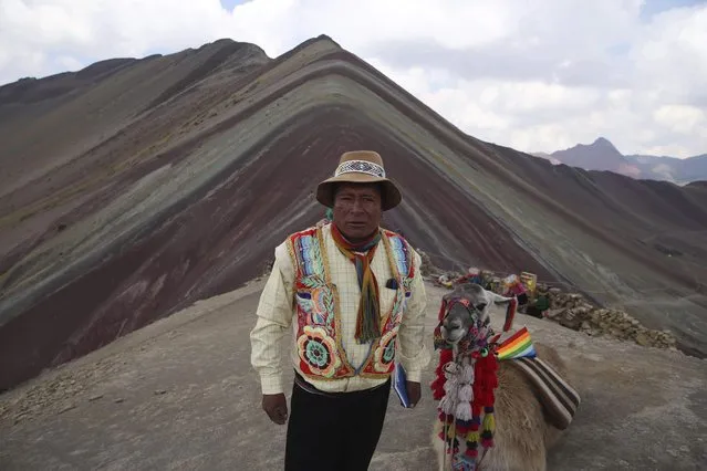 In this April 5, 2018 photo, community leader Gabino Human poses for a photo backdropped by Rainbow Mountain, in Pitumarca, Peru. A surge in tourists comes with a responsibility to be good stewards of the environment and their new guests, says Huaman, who admits he's not sure they are ready to fully handle it. (Photo by Martin Mejia/AP Photo)