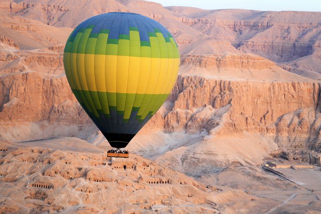 Tourists in a hot air balloon ride fly over the Valley of Kings in the southern city of Luxor, Egypt, Saturday, October 4, 2025, where the tomb of Amenhotep III, who ruled ancient Egypt between 1390 B.C. and 1350 B.C., is opened to visitors for the first time in more than two decades. (Photo by Amr Nabil/AP Photo)
