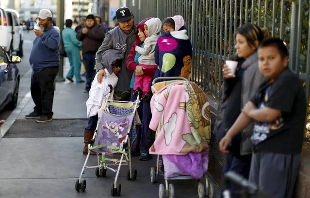 People wait in line for an early Thanksgiving meal served to the homeless at the Los Angeles Mission in Los Angeles, California November 25, 2015. (Photo by Mario Anzuoni/Reuters)