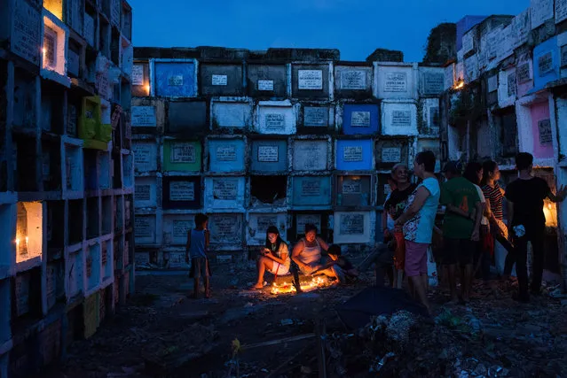 Millions of Filipinos flock to cemeteries around the country to visit departed relatives and loved ones as they mark All Saints Day on November 1, 2016 in Manila, Philippines. The “Day of the Dead” which is also called “Todos Los Santos” or “All Saint's Day” is a holiday celebrated in Latin cultures around the world during which family and friends of the deceased gather at the cemeteries to pray and hold vigils for those who have passed away. In the Philippines, family members clean tombs and often spend the night at the cemetery eating and celebrating with loved ones. (Photo by Dondi Tawatao/Getty Images)