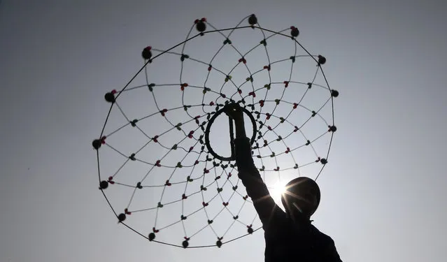 An Indian Sikh devotee performs martial arts during a religious procession ahead of the birth anniversary of the tenth Sikh Guru, Gobind Singh, in Jammu, India, 18 January 2021. Guru Gobind Singh became leader of the Sikhs at age nine and founded the Sikh warrior community called Khalsa. Sikhs celebrate the Guru's birthday on 20 January annually. (Photo by Jaipal Singh/EPA/EFE)