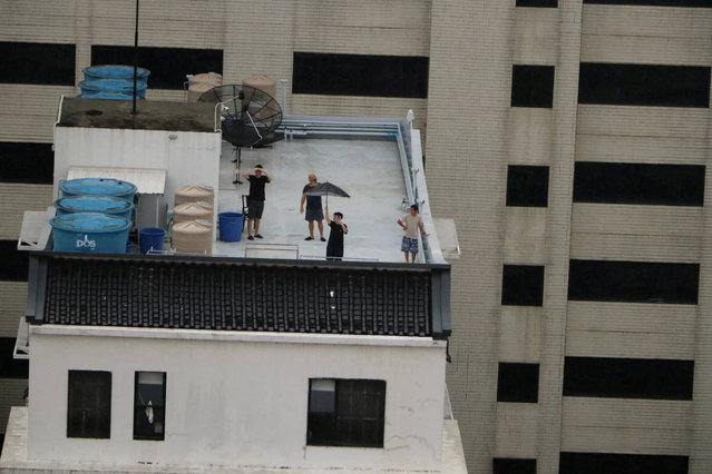 Stranded local residents wait on the rooftop of a submerged building for relief supplies, in a flooded area in Hat Yai district, which was affected by heavy rainfall, impacting several provinces in southern Thailand and killing several people, in Songkhla province, Thailand, November 26, 2025. (Photo by Royal Thai Army/Handout via Reuters)