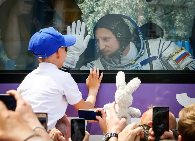 International Space Station (ISS) crew member Sergey Prokopyev of Russia waves to his family from a bus shortly before leaving to board the spacecraft at the Baikonur Cosmodrome, Kazakhstan June 6, 2018. (Photo by Shamil Zhumatov/Reuters/Pool)