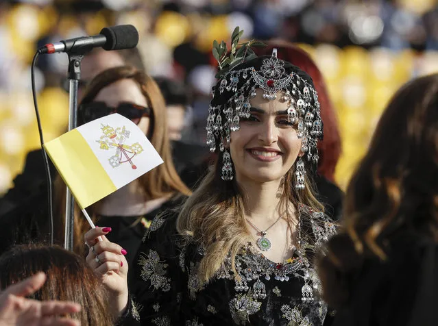 People wait for Pope Francis to celebrate mass at the Franso Hariri Stadium in Irbil, Kurdistan Region of Iraq, Sunday, March 7, 2021. The Vatican and the pope have frequently insisted on the need to preserve Iraq's ancient Christian communities and create the security, economic and social conditions for those who have left to return (Photo by Andrew Medichini/AP Photo)