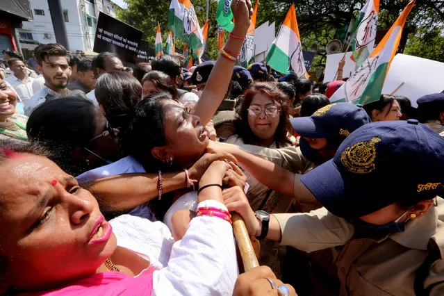 Indian policewomen try to control Madhya Pradesh Congress party workers as they protest against the  Bharatiya Janta Party (BJP)-led state government in Bhopal, India, 08 March 2021. Thousands of Congress activists and women gathered and held a street protest against the price hike and government policies and also to mark the International women's day. (Photo by Sanjeev Gupta/EPA/EFE)