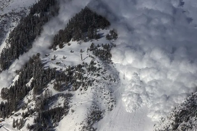 An artificially triggered avalanche thunders down a mountain side at the Vallee de la Sionne in Anzere near Sion, February 3, 2015. (Photo by Denis Balibouse/Reuters)