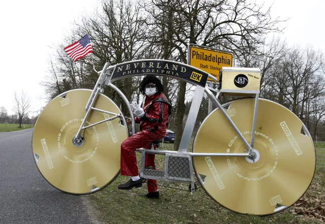 German bicycle designer Didi Senft, poses in a costume with a self-made bike honouring the late U.S. singer Michael Jackson in the village of Philadelphia near Storkow, some 50 km (31 miles) south of the German capital Berlin, April 6, 2010. Senft, a cycling fan better known as “El Diablo” from the Tour de France, is to embark on a 13-day tour with his bike, visiting capitals around Europe to pay tribute to Michael Jackson. (Photo by Thomas Peter/Reuters)