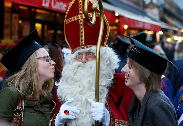Saint Nicholas poses with students during a traditional parade in central Brussels, Belgium December 3, 2016. (Photo by Yves Herman/Reuters)