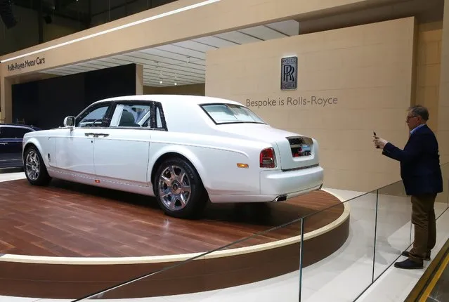 A man takes a picture of Rolls-Royce Serenity car ahead of the 85th International Motor Show in Geneva, March 2, 2015.            REUTERS/Arnd Wiegmann (SWITZERLAND  - Tags: TRANSPORT BUSINESS)  