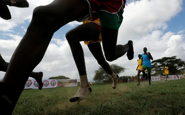 Maasai moran athletes run without shoes in the 800-meter race during the 2016 Maasai Olympics at the Sidai Oleng Wildlife Sanctuary, at the base of Mt. Kilimanjaro, near the Kenya-Tanzania border in Kimana, Kajiado, Kenya December 10, 2016. (Photo by Thomas Mukoya/Reuters)