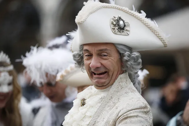 A man impersonating Giacomo Casanova smiles in St. Marks' Square, during the Carnival, in Venice, Italy, Sunday, January 24, 2016. Authorities have increased surveillance throughout the city and increased the number of officers on patrol, both under-cover and in uniform, but backed down on a proposal to ban revelers from wearing masks on the occasion of the Venice Carnival. (Photo by Luca Bruno/AP Photo)