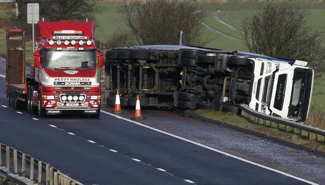 An overturned lorry lies on the hard shoulder of the M9 near Stirling in Scotland, Britain January 29, 2016. Severe weather warnings are in place in parts of Scotland as storm Gertrude rolls in packing winds of up to 90mph (144kph). (Photo by Russell Cheyne/Reuters)