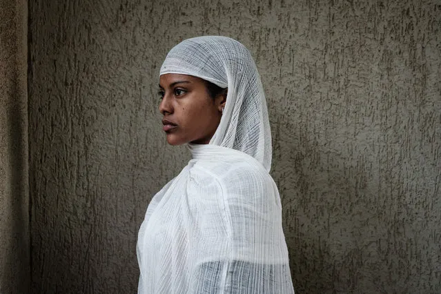 An Ethiopian Orthodox devotee waits to attend the Saint Michael's anniversary celebration at St. Michael church in Mekele, the capital of Tigray region, Ethiopia, on June 19, 2021. (Photo by Yasuyoshi Chiba/AFP Photo)