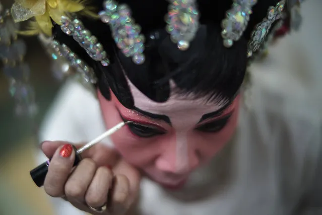 A member of a Chinese opera troupe applies make-up before a performance at a shopping mall ahead of the Chinese Lunar New Year celebrations in Bangkok, Thailand, February 4, 2016. (Photo by Athit Perawongmetha/Reuters)