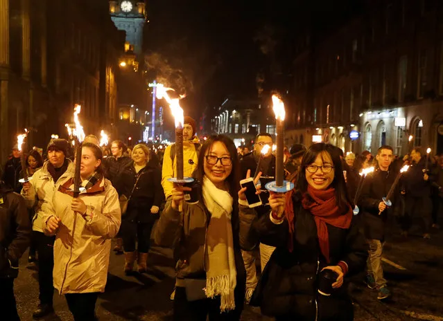Participants follow the Up Helly Aa vikings from the Shetland Islands who led the annual torchlight procession to mark the start of Hogmanay (New Year) celebrations in Edinburgh, Scotland December 30, 2016. (Photo by Russell Cheyne/Reuters)