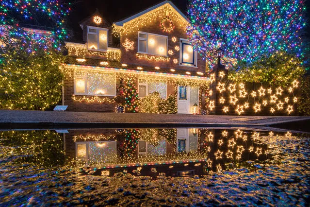 Christmas lights are displayed on houses in Trinity Close in Burnham-on-Sea on December 6, 2018 in Somerset, England. For over eleven years, the residents of Trinity Close, dubbed 'Britains most festive street have decorated their homes and gardens with more than a 100,000 colourful Christmas lights. Last year, the residents raised a record sum of £13,329 for local charities and since starting the festive display have raised over £85,000 for charitable causes. The display will be lit every night until early January. (Photo by Matt Cardy/Getty Images)