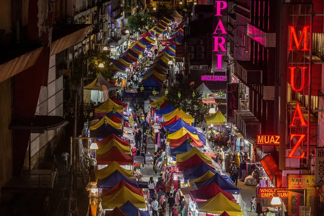 Rows of bazaar stalls line a street during the holy month of Ramadan in Kuala Lumpur, on April 25, 2021. During the holy month of Ramadan, a daily bazaar offers various selections of clothing, food, prayer mats and other religious items to Muslims who traditionally shop for new outfits to welcome the end of the month, Eid al-Fitr celebrations in Malaysia. (Photo by Mohd Firdaus/NurPhoto/Rex Features/Shutterstock)