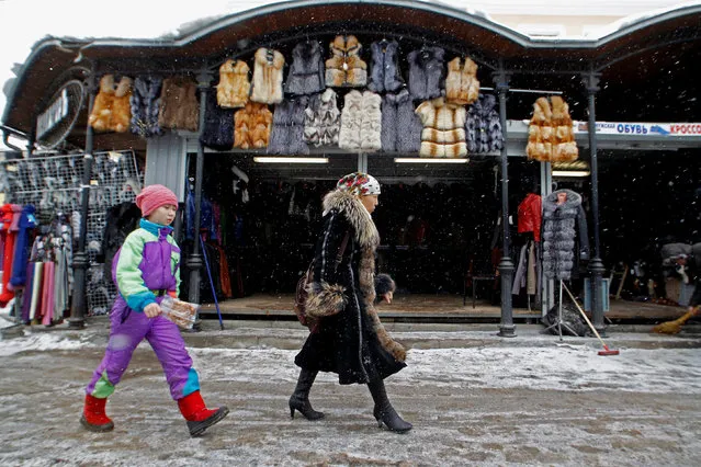 People walk past a shop in Apraksin Dvor, a market which has existed since the eighteenth century, in central St. Petersburg, Russia February 20, 2013. (Photo by Alexander Demianchuk/Reuters)