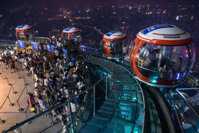 Tourists take ferris wheel at the top of Guangzhou Tower on September 26, 2022 in Guangzhou, Guangdong Province of China.The Guangzhou Tower Ferris Wheel is located 450 meters above the top of the tower and consists of 16 sightseeing golf cabins. It is the highest ferris wheel in the world. Tourists can enjoy the night view of Guangzhou from all angles. (Photo by Stringer/Anadolu Agency via Getty Images)