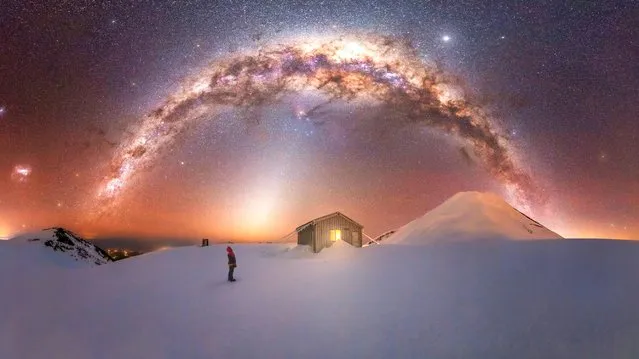 The Milky Way forms an arc over the volcanic Mount Taranaki in New Zealand where the photographer climbed for four hours in minus 15°C temperatures to capture a magical shot in 2021. (Photo by Larryn Rae/Capture the Atlas/Triangle News)