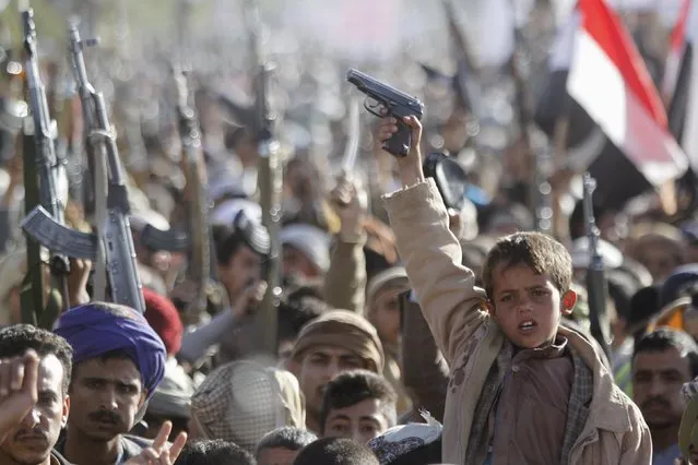 A boy shouts slogans as he raises a gun during a rally against U.S. support to Saudi-led air strikes, in Yemen's capital Sanaa, February 19, 2016. (Photo by Mohamed al-Sayaghi/Reuters)