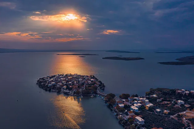 An aerial view of Golyazi neighborhood, also known as with its ancient name 'Apollonia ad Rhyndacum', located on a small peninsula on the shores of Uluabat Lake during sunset in Nilufer district of Bursa, Turkiye on October 04, 2023. Golyazi is an important settlement in terms of the common history of Turks and Greeks. The region, which was declared a protected area, is known as one of the richest ancient settlements in Bursa. (Photo by Hamit Yalcin/Anadolu Agency via Getty Images)