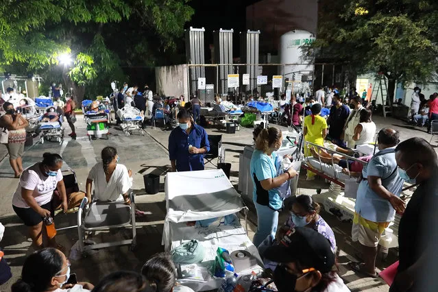 Doctors and patients outside a hospital after being evacuated following a 7.0 magnitude earthquake in Acapulco, Mexico, 07 September 2021.​ The earthquake was also felt in Mexico City. (Photo by David Guzman/EPA/EFE)