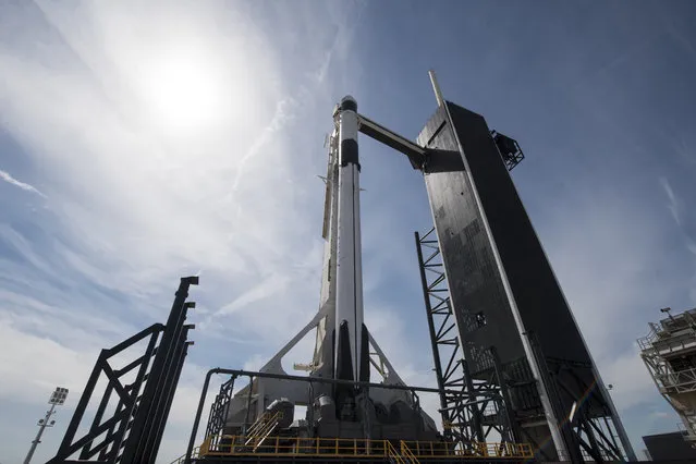 In this image released by NASA, a Falcon 9 SpaceX rocket, ready for launch, sits on pad 39A at the Kennedy Space Center in Cape Canaveral, Fla., Friday, March 1, 2019. The spacecraft's unmanned test flight with the Dragon capsule is scheduled for launch early Saturday morning. (Photo by Joel Kowsky/NASA via AP Photo)