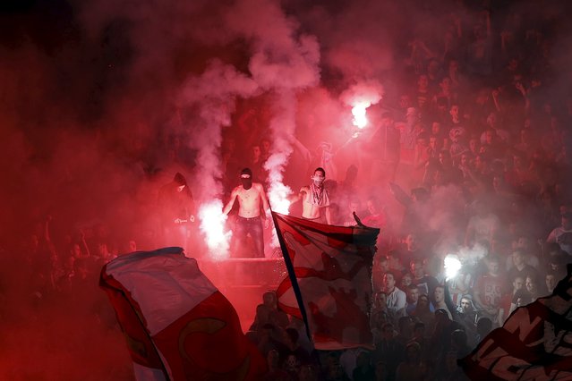 Red Star Belgrade fans cheer and light flares during their Serbian Superliga soccer match against Partizan Belgrade in Belgrade, April 25, 2015. (Photo by Marko Djurica/Reuters)