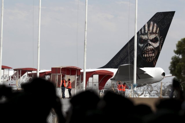 Fans of British heavy metal band Iron Maiden watch as Ed Force One, the band's aeroplane, arrives ahead of their concert as part of The Book of Souls World Tour at El Salvador International Airport in San Luis Talpa, El Salvador March 5, 2016. (Photo by Jose Cabezas/Reuters)