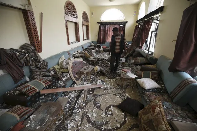 A guard walks inside a house damaged after an air strike by a Saudi-led coalition struck a nearby missile base, in Yemen's capital Sanaa April 27, 2015. (Photo by Mohamed al-Sayaghi/Reuters)
