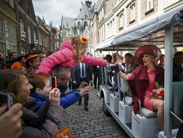 Queen Maxima of the Netherlands (R) greets people during a parade on King's Day in Dordrecht, the Netherlands April 27, 2015. The Dutch are celebrating the “King's Day”, a national holiday held in honour of the Netherlands' monarch, King Willem-Alexander. (Photo by Phil Nijhuis/Reuters)