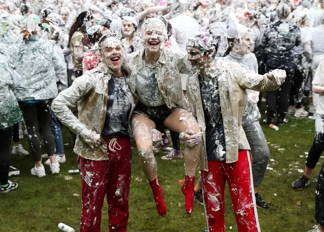 Students from St Andrews University are covered in foam as they take part in the traditional “Raisin Weekend” in the Lower College Lawn, at St Andrews in Scotland, Britain on October 18, 2021. (Photo by Russell Cheyne/Reuters)